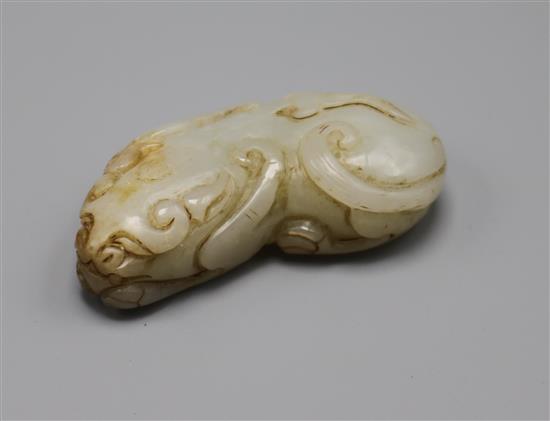 A Chinese pale celadon and russet jade figure of a lion-dog, Qing dynasty